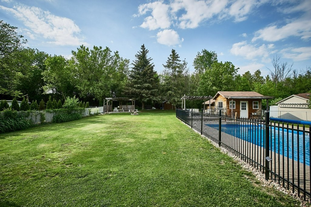 Backyard and swimming pool at a waterfront home in Brooklin, Ontario